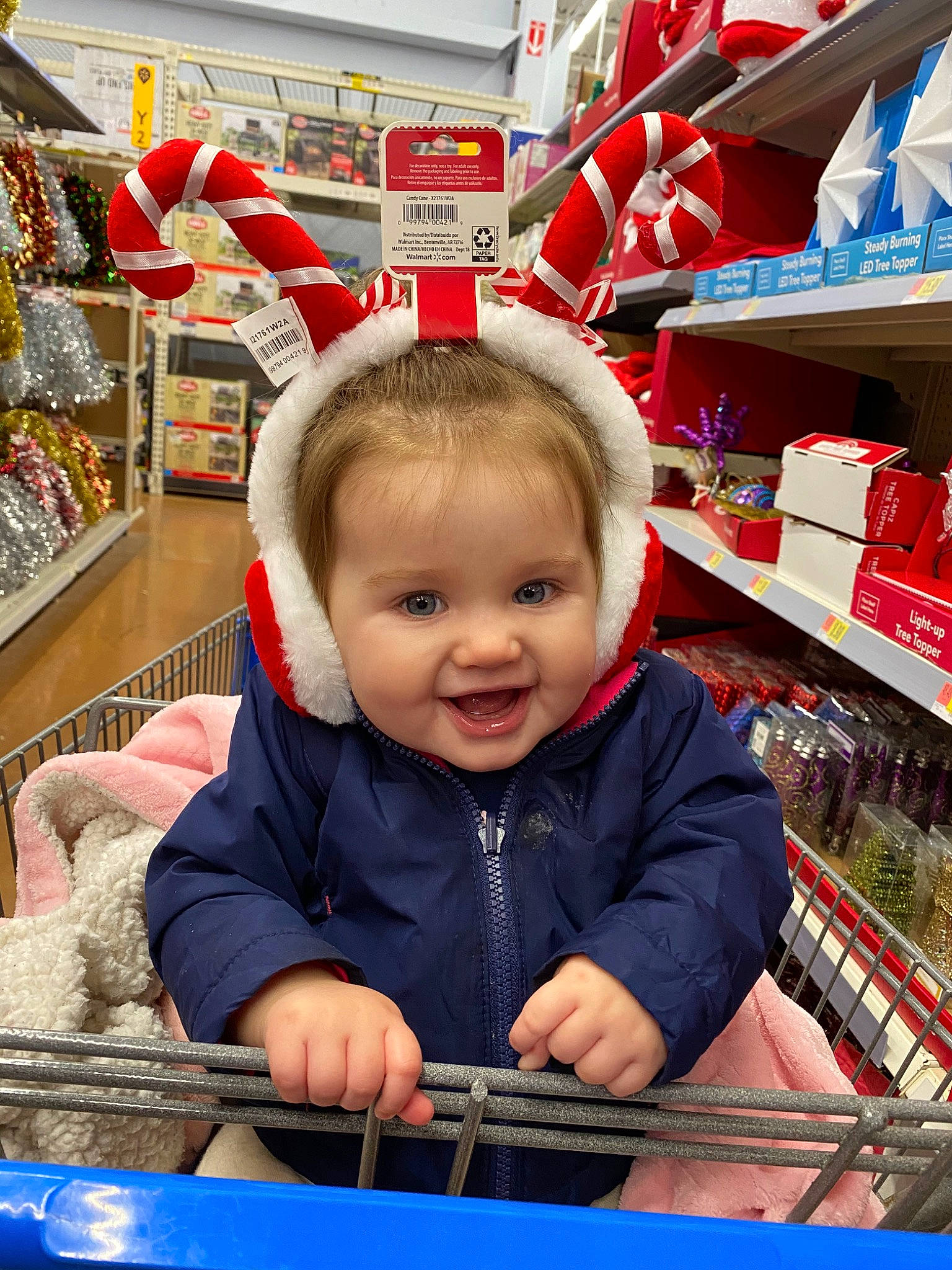 Kira is registered to the contest to win money with this photo: child, grocery_store, joy, person, retail, shopping_cart, supermarket, toddler, vehicle
