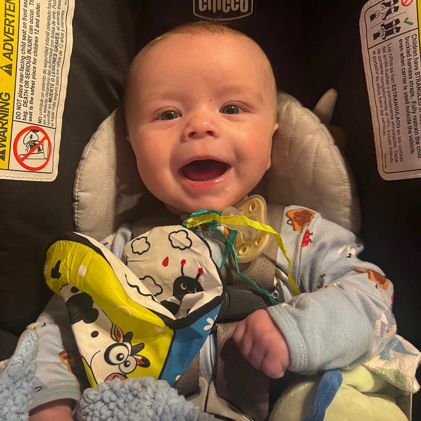 Dean joined the competition — help win amazing prizes! baby, blanket, car_seat, chicco, child, clothing, colorful, comfort, cute, face, happy, indoor, infant, pacifier, person, portrait, seatbelt, smiling, soft_toy, toy