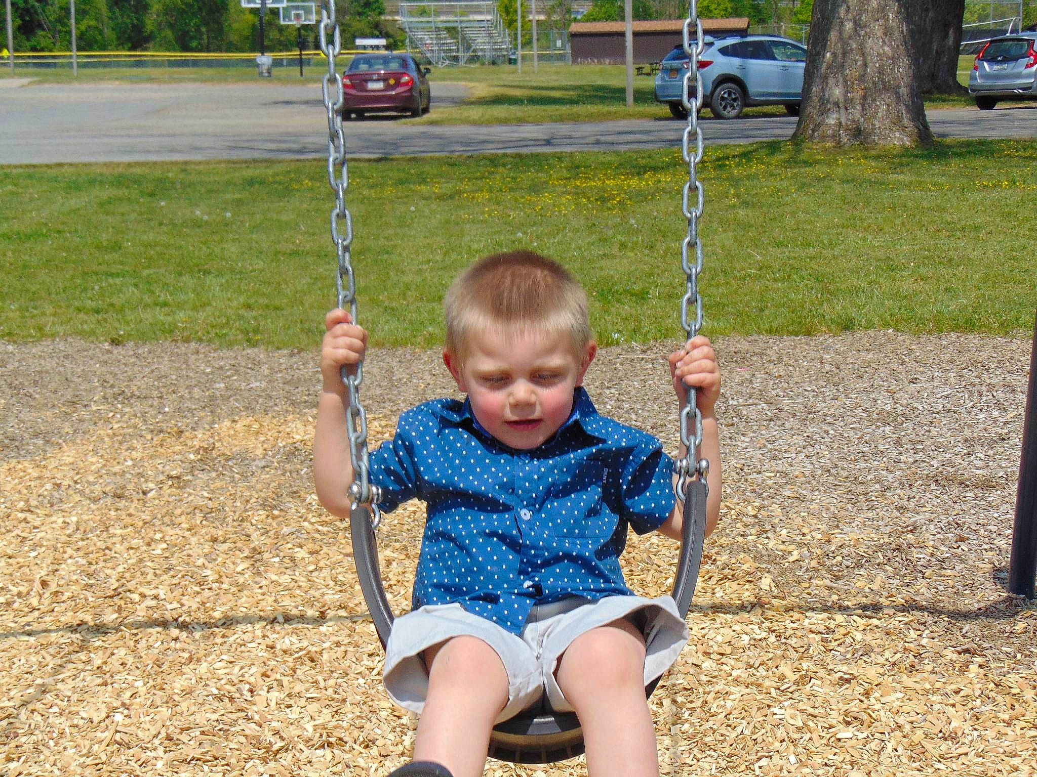 Gavin is registered to the contest to win money with this photo: baby, car, city, fun, grass, happy, human_settlement, leaf, leisure, person, plant, playground, public_space, recreation, shorts, smile, summer, swing, toddler, tree