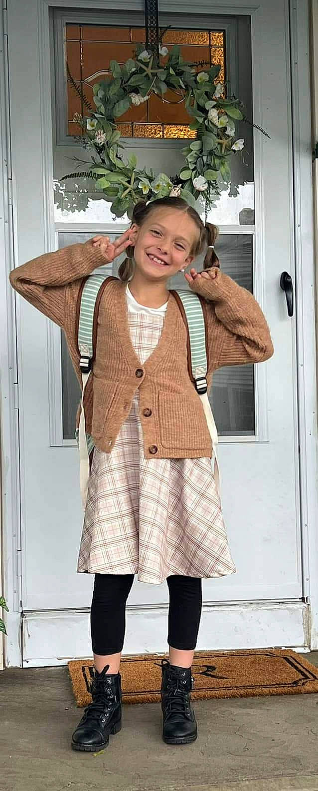 Addyson is registered to the contest to win money with this photo: belt, blazer, collar, face, fashion, fashion_design, hairstyle, hat, jewellery, joy, knee, neck, necklace, outerwear, pattern, person, plaid, sleeve, smile, tartan