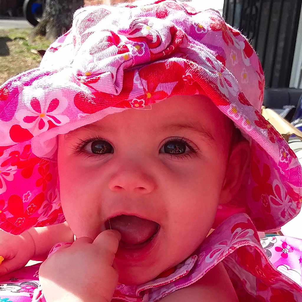 Alison is registered to the contest to win money with this photo: baby, bonnet, cheek, child, face, headgear, headwear, lip, mouth, person, pink, smile, sun_hat, toddler