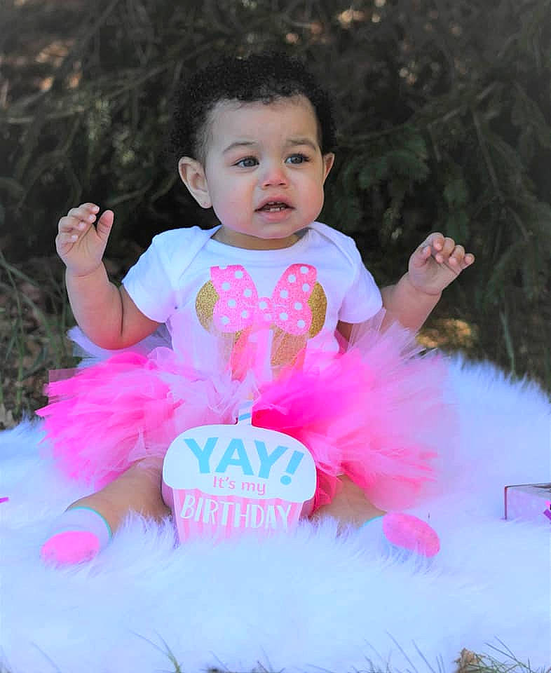 Jazlyn is registered to the contest to win money with this photo: baby, baby_products, baby_toddler_clothing, ballet_tutu, child, costume, event, formal_wear, fun, grass, happy, magenta, person, pink, ruffle, sitting, skin, sweetness, textile, toddler