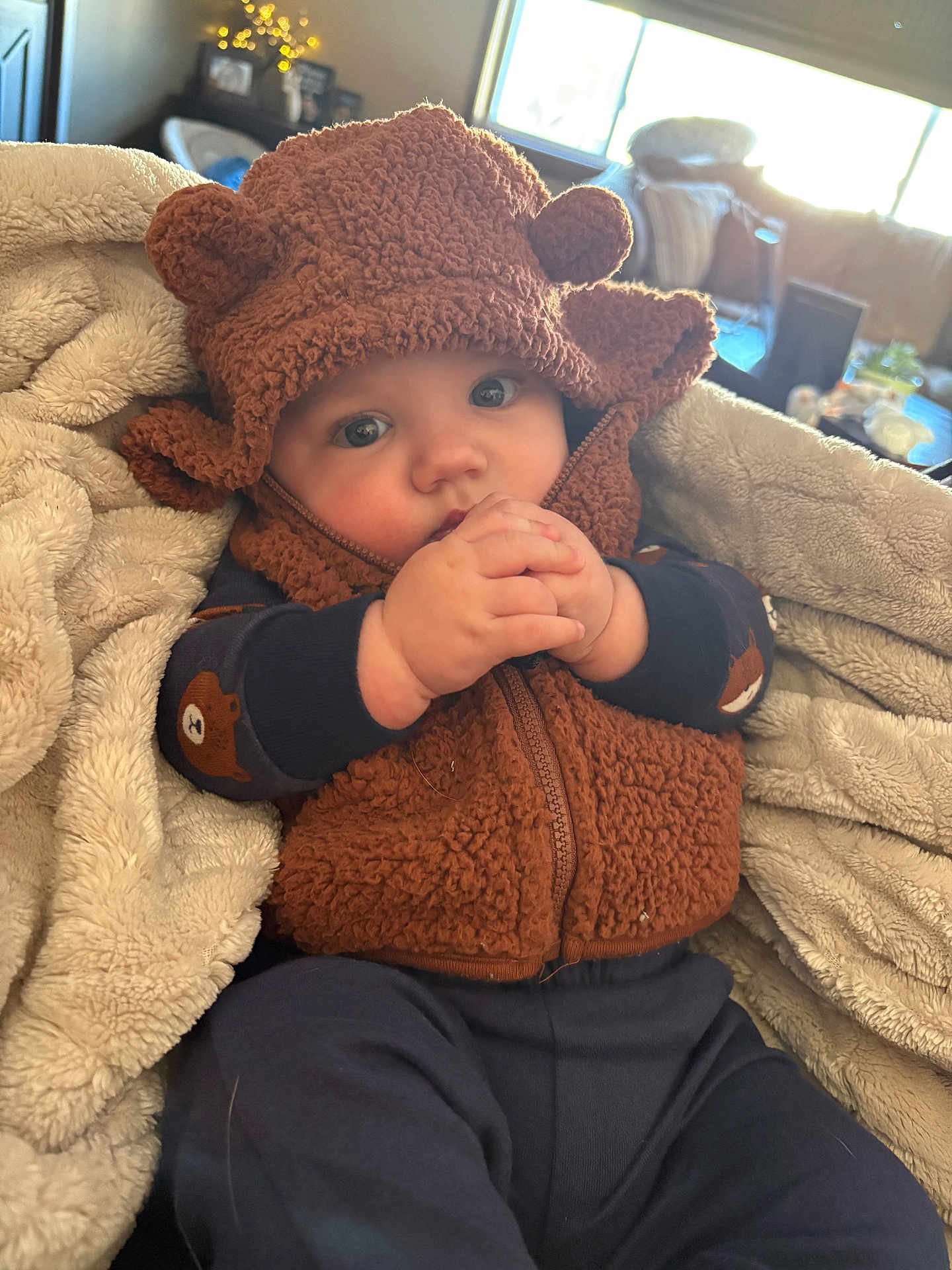 Colten joined the competition — help win amazing prizes! baby, child, hoodie, brown, fuzzy, blanket, indoor, cute, hands, face, blue_eyes, cozy, warm_clothing, portrait, infant, sitting, soft_texture, cuddle, baby_clothes, adorable
