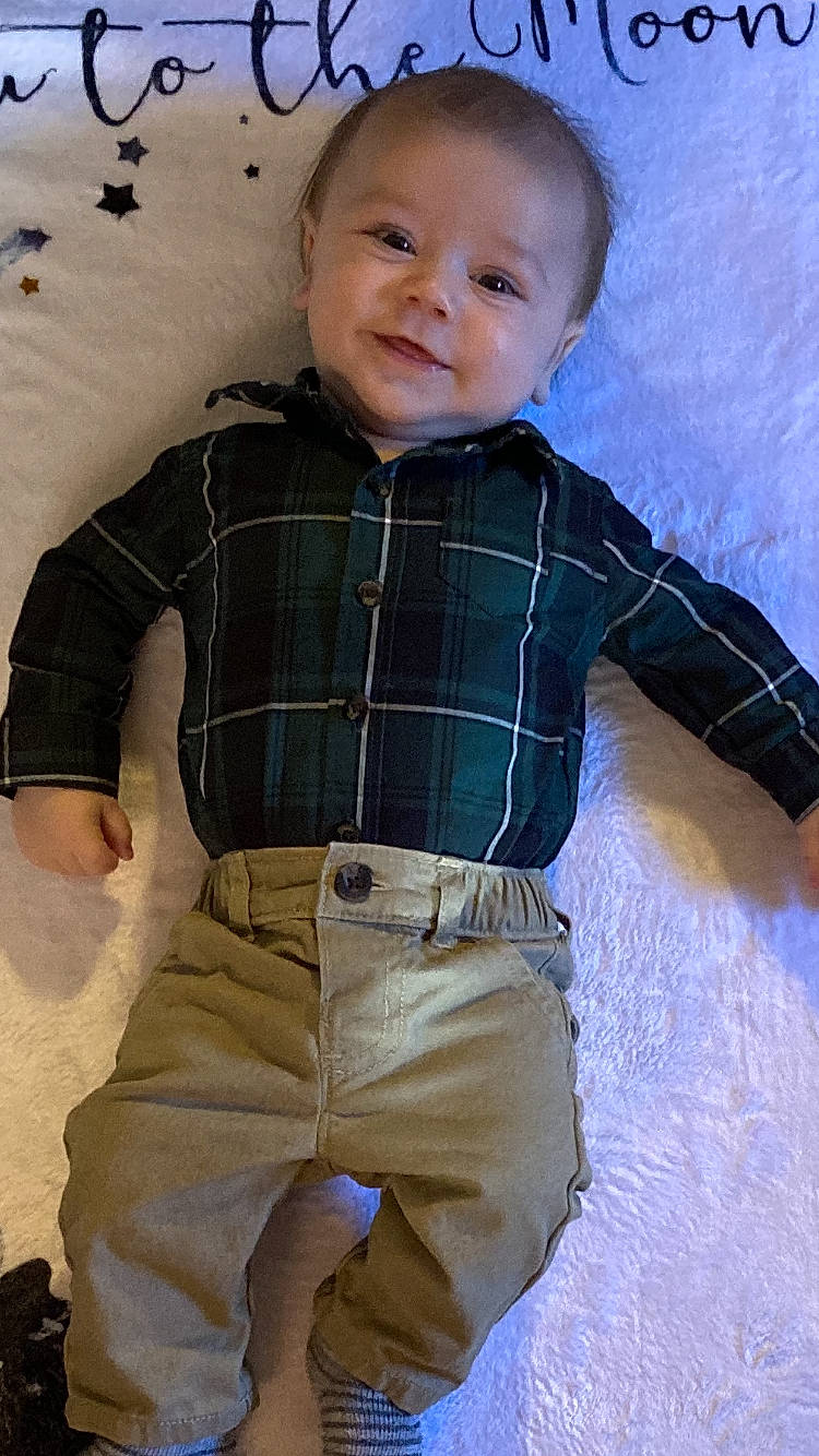 Joey is registered to the contest to win money with this photo: baby, cheek, child, design, pattern, person, plaid, sleeve, toddler, trunk