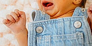 Breanna joined the competition — help win amazing prizes! baby, denim, overalls, crying, infant, fist, blanket, texture, closeup, skin, face, expression, newborn, clothing, cute, sleeping_area, child, soft, head, portrait
