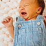 baby, denim, overalls, crying, infant, fist, blanket, texture, closeup, skin, face, expression, newborn, clothing, cute, sleeping_area, child, soft, head, portrait