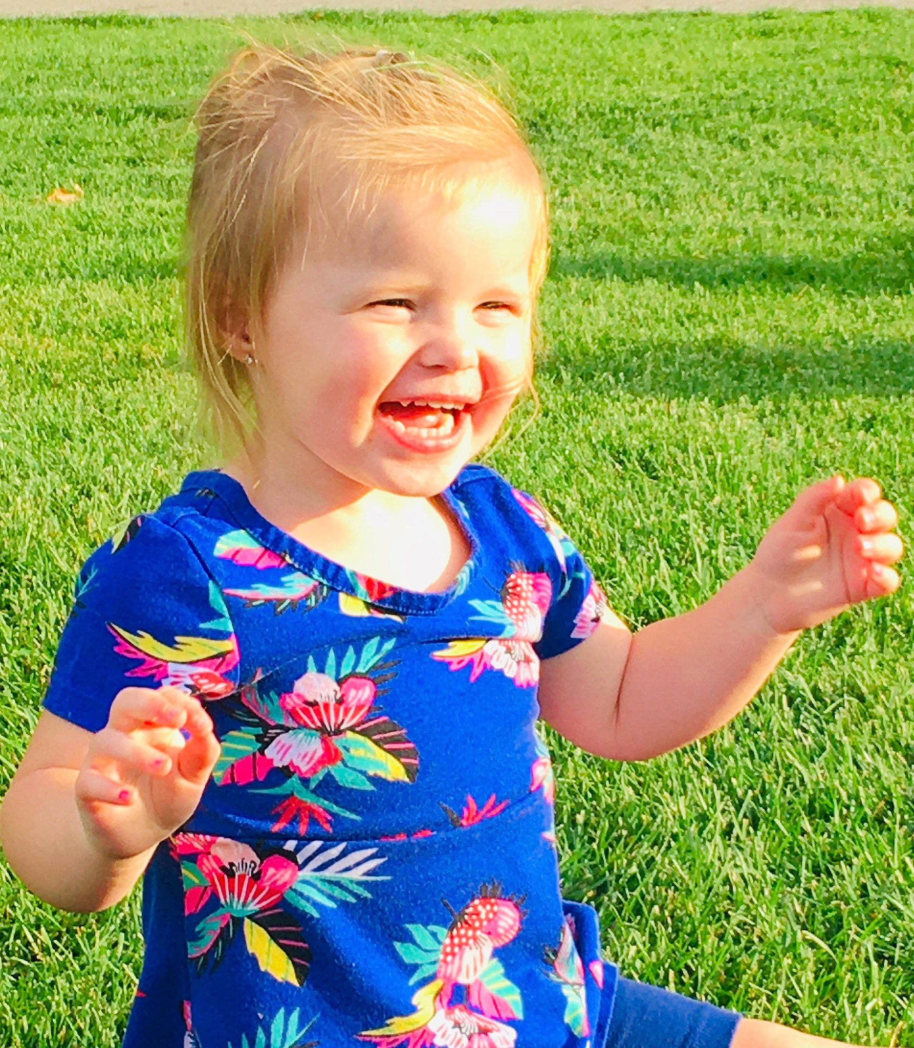 Camdyn is registered to the contest to win money with this photo: baby, baby_toddler_clothing, child, day_dress, field, finger, grass, grass_family, hand, happy, laugh, lawn, meadow, mouth, pattern, people_in_nature, person, prairie, summer, thumb
