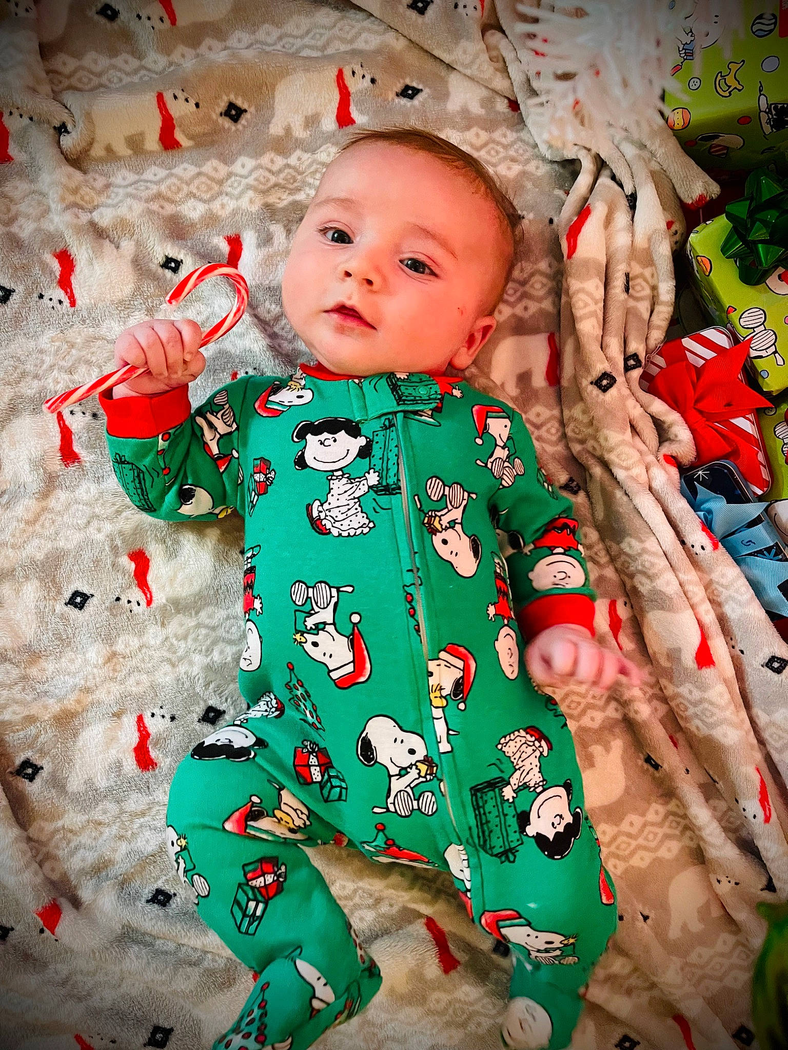 Kaiser is registered to the contest to win money with this photo: baby, baby_toddler_clothing, cheek, child, christmas, design, dress, event, eye, facial_expression, fun, happy, holiday, pattern, people_in_nature, person, sitting, sleeve, standing, textile