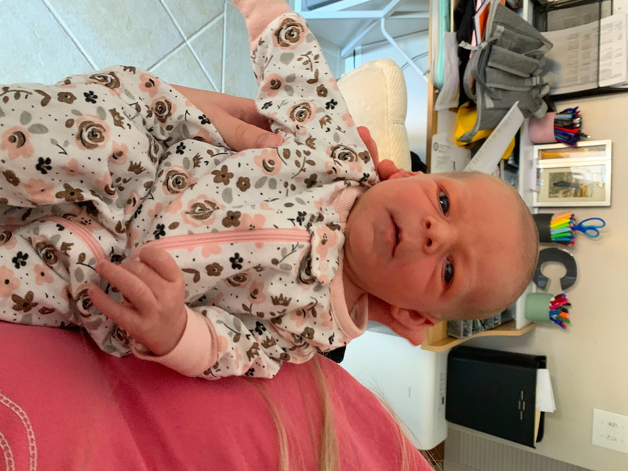 Lillian is registered to the contest to win money with this photo: abdomen, baby, baby_products, baby_toddler_clothing, child, comfort, fashion_design, happy, hat, hospital, human_leg, pattern, peach, people, person, pink, skin, sleeve, textile, thigh