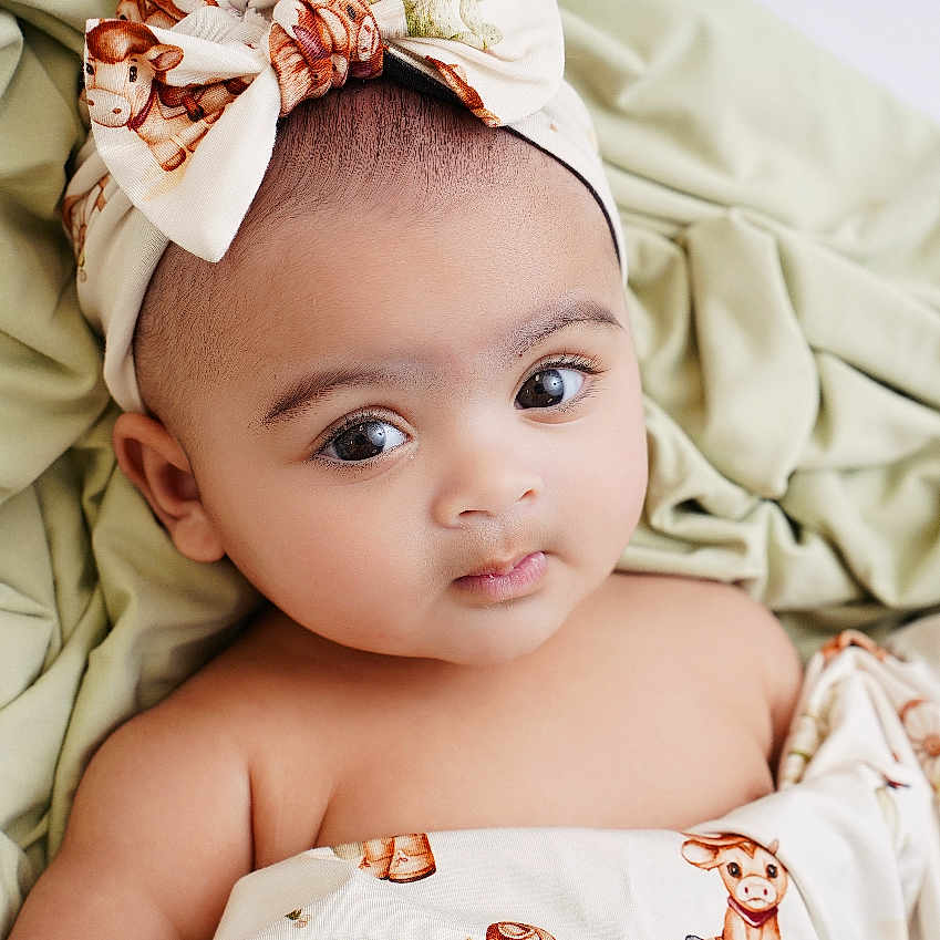 Adelyn Sunday joined the competition — help win amazing prizes! accessories, baby, bed, blanket, bodypart, bonnet, clothing, face, finger, furniture, hand, happy, hat, head, headband, newborn, person, photography, portrait, smile