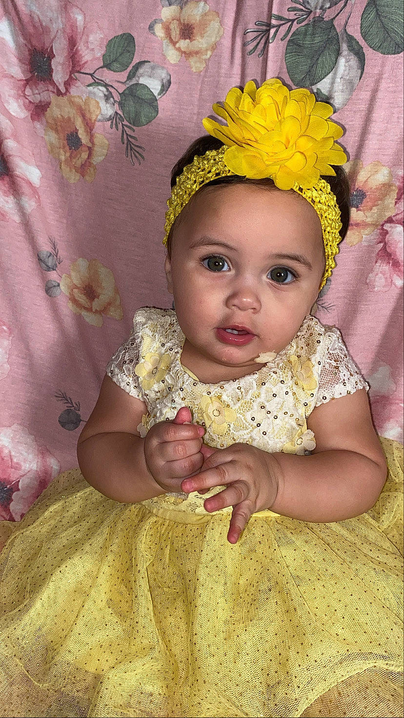 Honey is registered to the contest to win money with this photo: baby, baby_toddler_clothing, bridal_accessory, costume_hat, dress, embellishment, eyelash, fun, hair_accessory, happy, headband, headgear, headpiece, iris, jewellery, necklace, peach, person, pink, skin