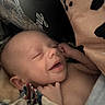 baby, infant, smiling, sleeping, blanket, cozy, cute, child, newborn, face, skin, hand, expression, comfort, resting, portrait, indoors, soft_light, peaceful, toddler