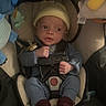 Ryan Jr joined the competition — help win amazing prizes! baby, infant, car_seat, yellow_hat, blue_clothes, red_socks, toy, safety_harness, cute, indoors, child, newborn, seatbelt, soft_lighting, curious_expression, small_hands, baby_accessories, car_seat_padding, child_safety, infant_care