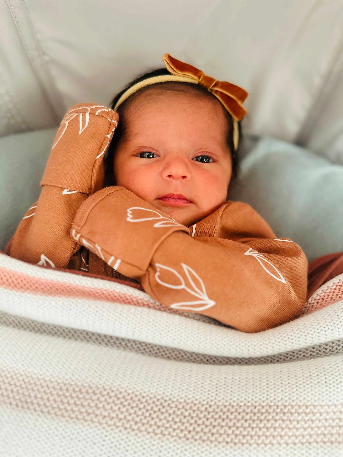 Zarajade is registered to the contest to win money with this photo: baby, infant, blanket, knit, brown_clothing, headband, bow, face, eyes, hands, cozy, soft_lighting, portrait, indoor, cute, newborn, child, calm, closeup, patterned_clothing