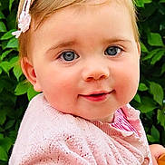 Lily-Grace joined the competition — help win amazing prizes! baby, child, face, blue_eyes, pink_sweater, hair_clip, smile, outdoor, green_leaves, portrait, cute, infant, closeup, knitwear, happy, young_child, natural_light, skin, person, head