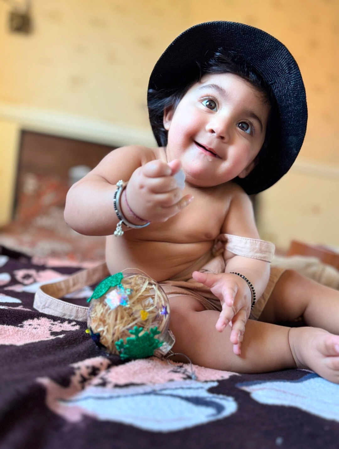 Gurviraat Singh is registered to the contest to win money with this photo: baby, child, hat, smile, happy, bare_chest, bracelet, toy, ball, blanket, indoor, cute, portrait, skin, hand, legs, sitting, playful, decorated, infant