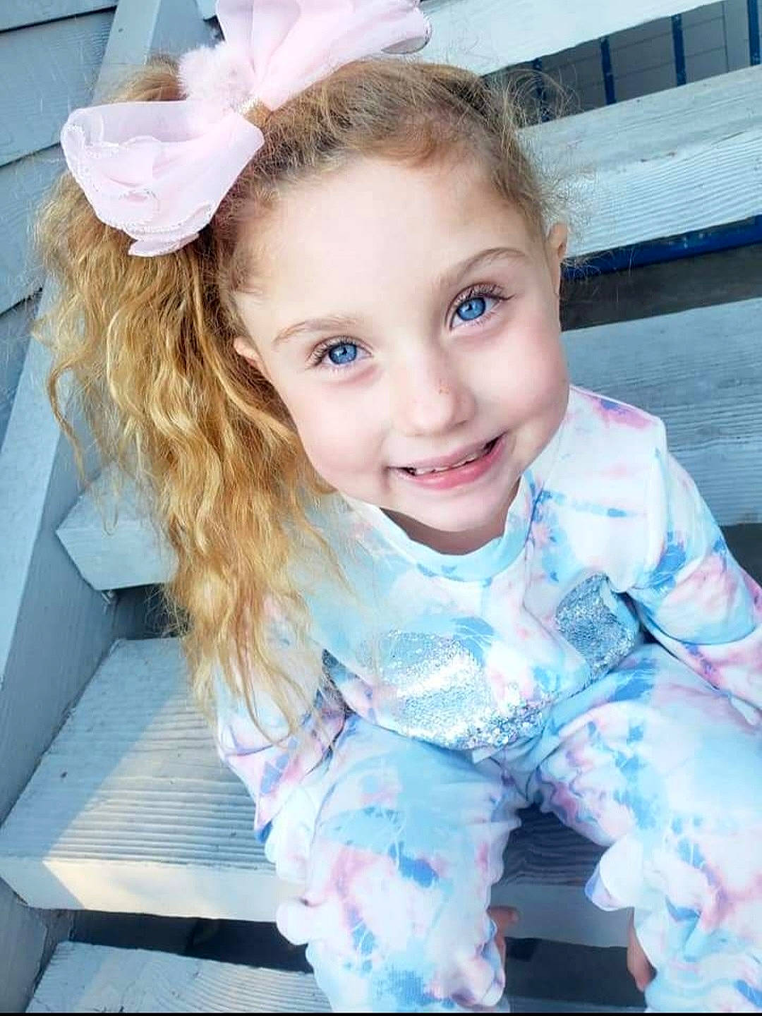 Stormy is registered to the contest to win money with this photo: baby_toddler_clothing, blue, chin, cool, eye, eyelash, face, flash_photography, fun, hairstyle, happy, iris, joy, person, pink, skin, sleeve, smile, standing, textile