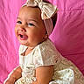 Lailah is registered to the contest to win money with this photo: baby, child, smiling, dress, headband, bow, pink_background, portrait, happy, cute, infant, sitting, lifestyle, fashion, elegant, indoors, person, toddler, face, cheerful
