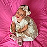 baby, infant, child, dress, headband, bow, pink_blanket, shoes, smile, happy, cute, sitting, indoors, portrait, young_child, clothing, footwear, fabric, baby_girl, playful
