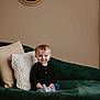 baby, child, smile, couch, pillow, mirror, indoor, cozy, portrait, cute, clothing, socks, seated, home, decor, young, infant, furniture, expression, relaxed