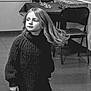 child, girl, sweater, black_and_white, indoor, floor, chair, table, long_hair, motion, portrait, person, clothing, tile_floor, furniture, casual, young, cute, expression, monochrome