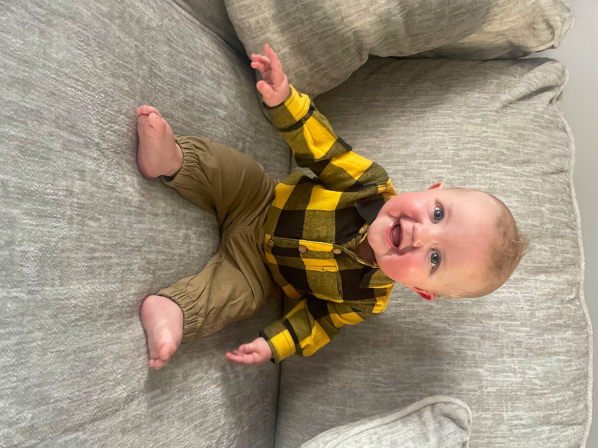 Brody is registered to the contest to win money with this photo: baby, baby_toddler_clothing, comfort, finger, flooring, foot, fun, gesture, happy, human_body, leg, linens, pattern, person, skin, sleeve, smile, textile, thumb, toddler