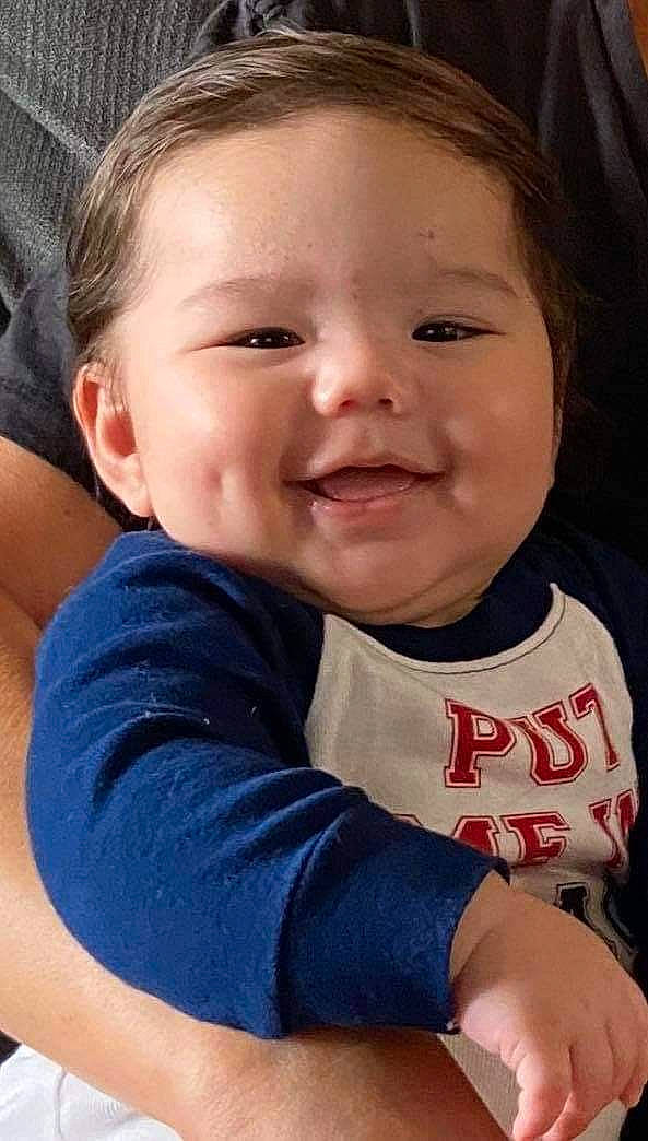 Skylar is registered to the contest to win money with this photo: arm, baby_toddler_clothing, cheek, chin, cool, eye, eyebrow, face, finger, gesture, hair, happy, head, iris, joy, lip, mouth, nose, person, skin