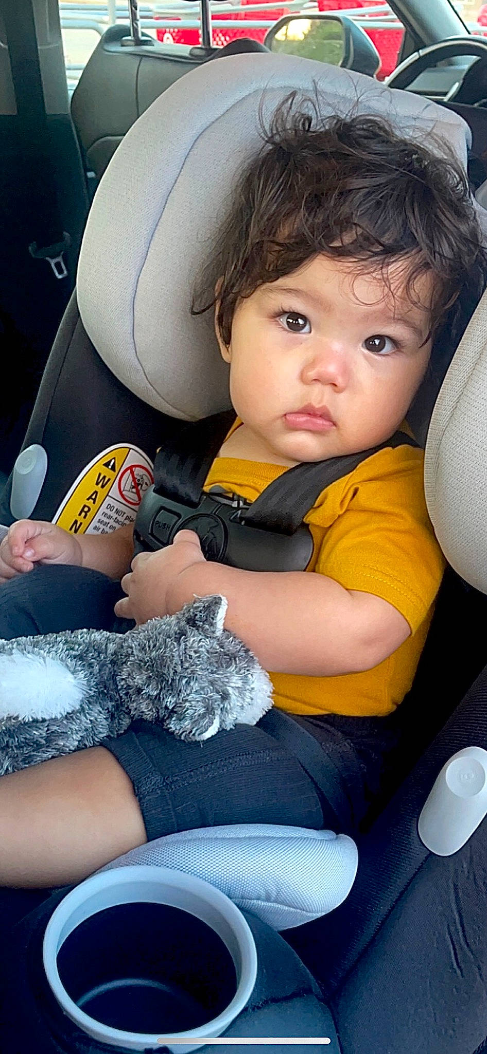 Skylar is registered to the contest to win money with this photo: arm, automotive_design, baby_in_car_seat, baby_toddler_clothing, car_seat, car_seat_cover, child, comfort, finger, hand, happy, human_body, lap, leg, person, product, skin, steering_wheel, thigh, toddler