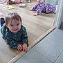 baby, babies, infant, crawling, wooden_floor, tiles, toys, stuffed_animal, book, bed, storage_box, playroom, childhood, smile, happy, clothing, floral_pattern, doorway, home_interior, portrait