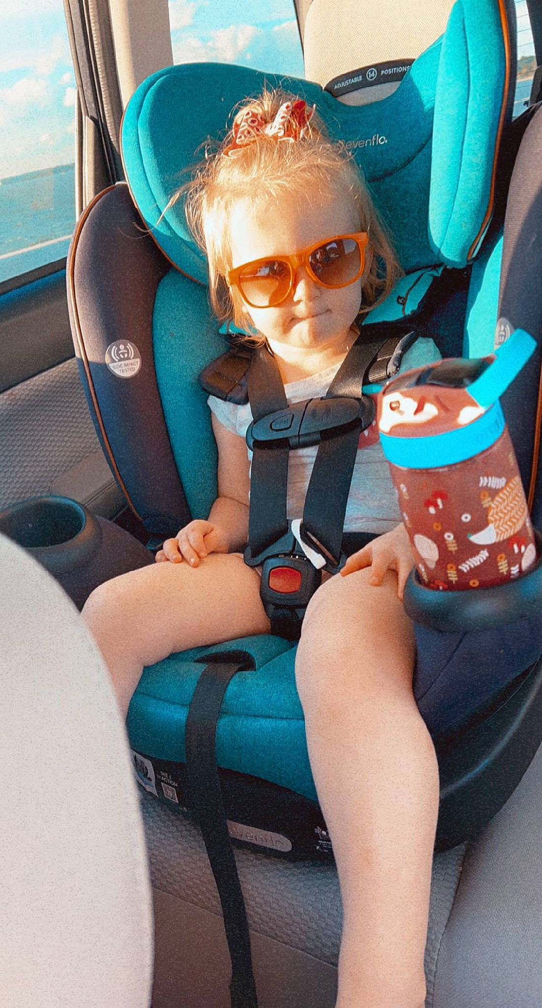 Harper is registered to the contest to win money with this photo: auto_part, automotive_design, blue, car_seat, car_seat_cover, comfort, electric_blue, eyewear, glasses, goggles, head_restraint, knee, lap, leg, motor_vehicle, person, sunglasses, thigh, toddler, vehicle_door