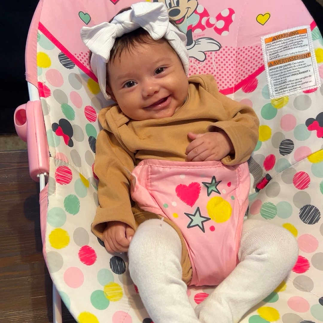 Zaiyah is registered to the contest to win money with this photo: baby, baby_rocker, brown_clothing, child, colorful, cute, fabric, happy, headband, indoor, infant, minnie_mouse, pattern, person, polka_dots, seat, smile, tights, toy, wooden_floor