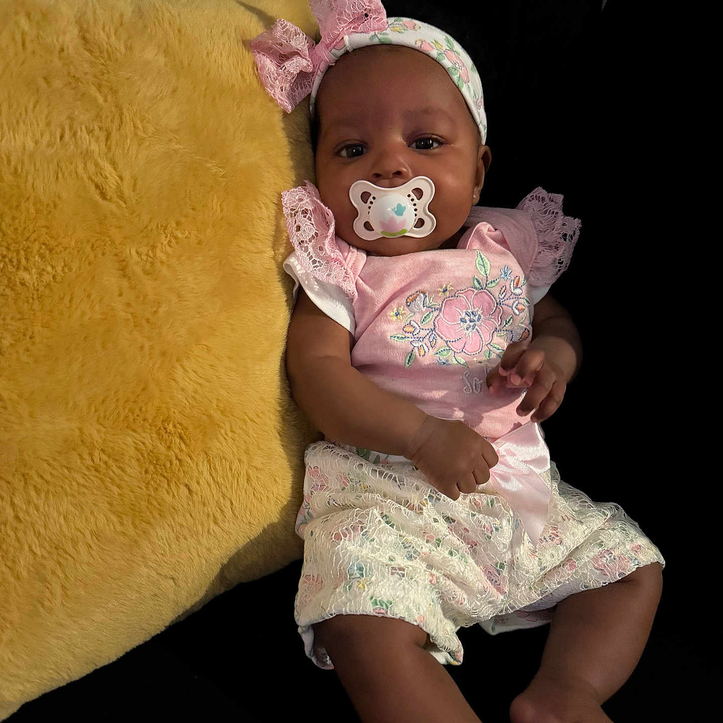 Jioni is registered to the contest to win money with this photo: baby, blanket, bodypart, bonnet, cap, clothing, couch, cushion, dress, face, finger, furniture, hand, hat, head, newborn, person, photography, portrait, sitting