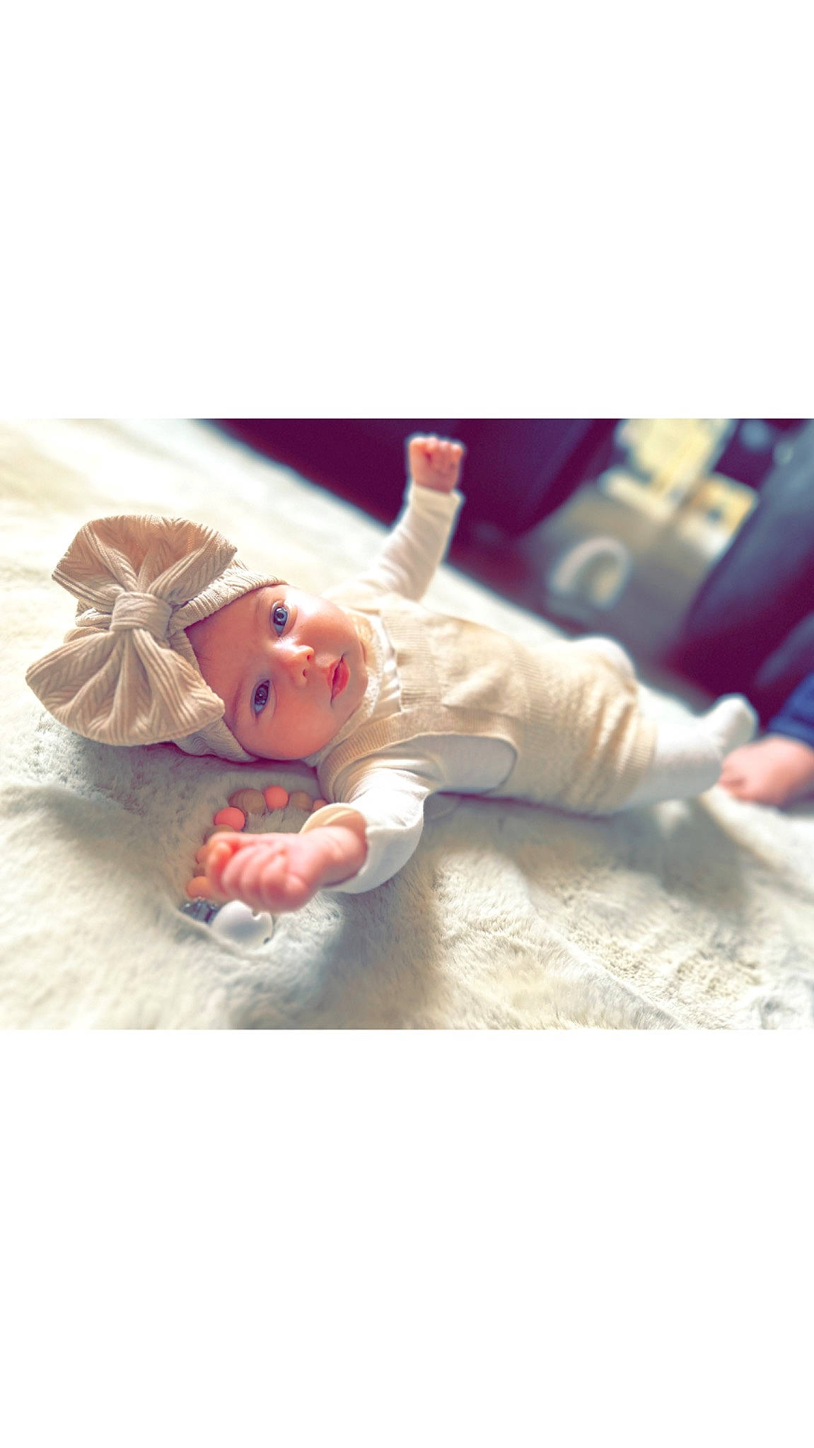 Anna participe au concours pour gagner de l'argent avec cette photo : baby, child, comfort, doll, fashion_accessory, flesh, flooring, foot, fur, gesture, happy, headwear, linens, peach, person, plush, sitting, stuffed_toy, teddy_bear, toddler
