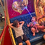 Isaïah a rejoint le concours — aidez-le/la à gagner de superbes lots ! amusement_park, baby, barefoot, carousel, child, curly_hair, family, fun, hand, horse, joy, light_wand, night, playful, ride, seat, shorts, smile, striped_shirt, toy