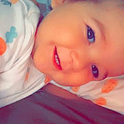 Isaïah participe au concours pour gagner de l'argent avec cette photo : baby, bed, blanket, child, closeup, cozy, cute, face, happy, indoors, infant, lying_down, person, portrait, resting, sleepwear, smile, soft_light, warm_colors, young