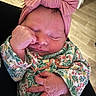 newborn, baby, infant, sleeping, headband, bow, floral_outfit, hand, fingers, face, closed_eyes, skin, person, indoor, wooden_floor, cute, peaceful, portrait, toddler, baby_clothes