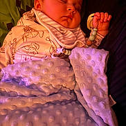 Xavier-James is registered to the contest to win money with this photo: baby, sleeping, blanket, pacifier, clothing, hand, face, infant, soft_texture, cute, comfort, rest, indoors, child, peaceful, nap, warm_lighting, cozy, toddler, bedtime