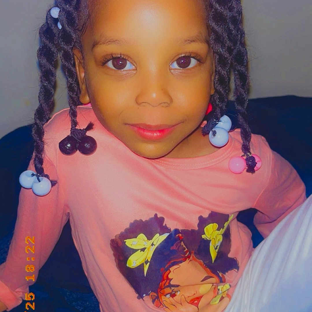 Kennedy joined the competition — help win amazing prizes! accessories, child, clothing, couch, cushion, earring, face, female, furniture, girl, hair, head, homedecor, jewelry, pants, person, photography, portrait, purple, t_shirt