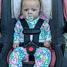 Brynnlee joined the competition — help win amazing prizes! baby, infant, child, car_seat, pacifier, harness, sitting, portrait, face, eyes, wide_eyed, colorful_clothing, hearts, stars, flowers, rainbows, indoors, safety_belt, pink, close_up