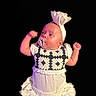 baby, infant, child, portrait, pacifier, headband, dress, ruffles, fists, arms_up, serious_expression, looking_sideways, face, skin, fashion, studio, black_background, close_up, costume, photography