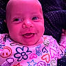 Brynnlee is registered to the contest to win money with this photo: baby, infant, child, smiling, happy, portrait, face, eyes, tongue, sitting, colorful_clothing, patterned_shirt, flowers, hearts, stars, smiley_faces, indoor, chair, purple_lighting, close_up
