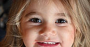 Kaylena joined the competition — help win amazing prizes! child, girl, toddler, portrait, close_up, smiling, happy, face, eyes, teeth, blonde_hair, long_hair, brown_eyes, white_shirt, indoor, soft_lighting, headshot, photography, cute, person