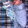 baby, sleeping, onesie, plush_toy, blue, infant, blanket, plaid, soft_toy, child, peaceful, cute, face, hand, footed_pajamas, indoors, resting, cozy, newborn, comfort