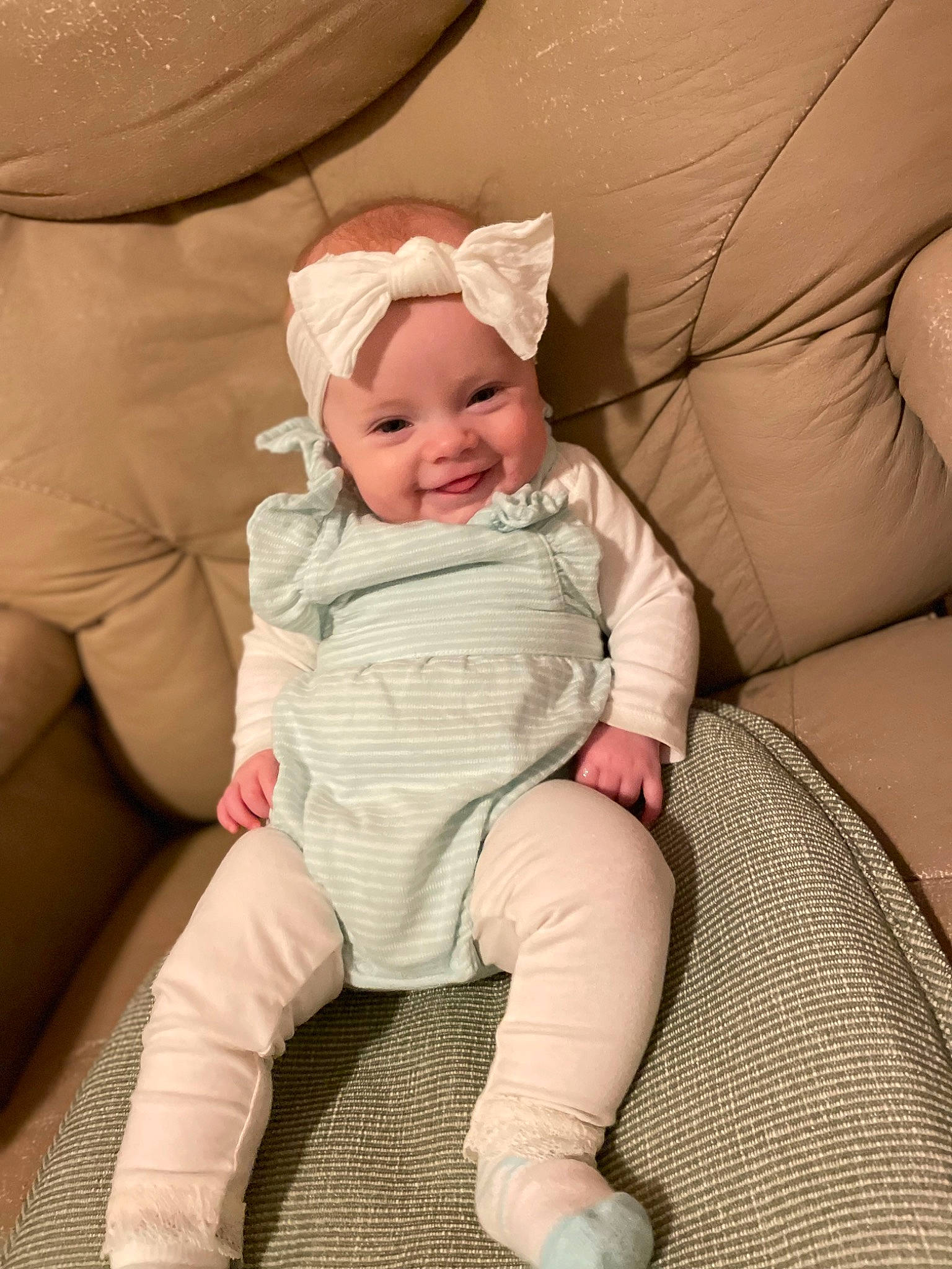 Eleanor is registered to the contest to win money with this photo: baby, baby_toddler_clothing, chair, cheek, comfort, couch, eye, face, finger, glasses, happy, head, headwear, human_body, joy, knee, mouth, person, skin, sleeve