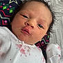 Heidi is registered to the contest to win money with this photo: baby, newborn, infant, face, eyes, hair, onesie, clothing, blanket, pattern, cute, portrait, lying_down, skin, expression, indoors, child, young, soft, small