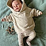 baby, blanket, bonnet, clothing, face, happy, hat, head, hood, hoodie, hosiery, knitwear, newborn, person, photography, portrait, smile, sock, sweater, sweatshirt