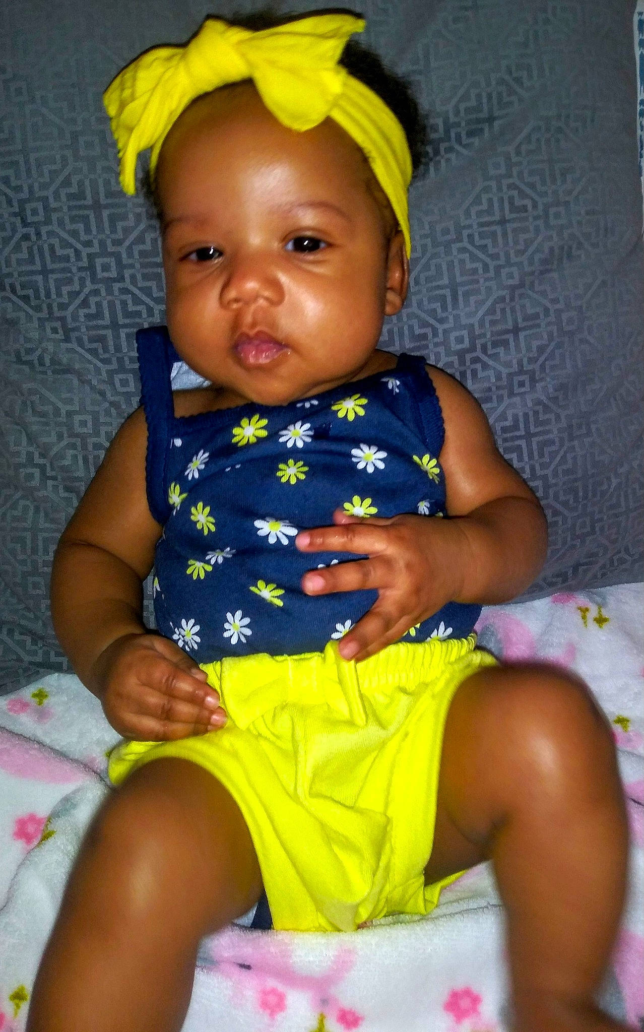 Emani joined the competition — help win amazing prizes! baby, baby_toddler_clothing, child, person, sitting, smile, toddler, yellow