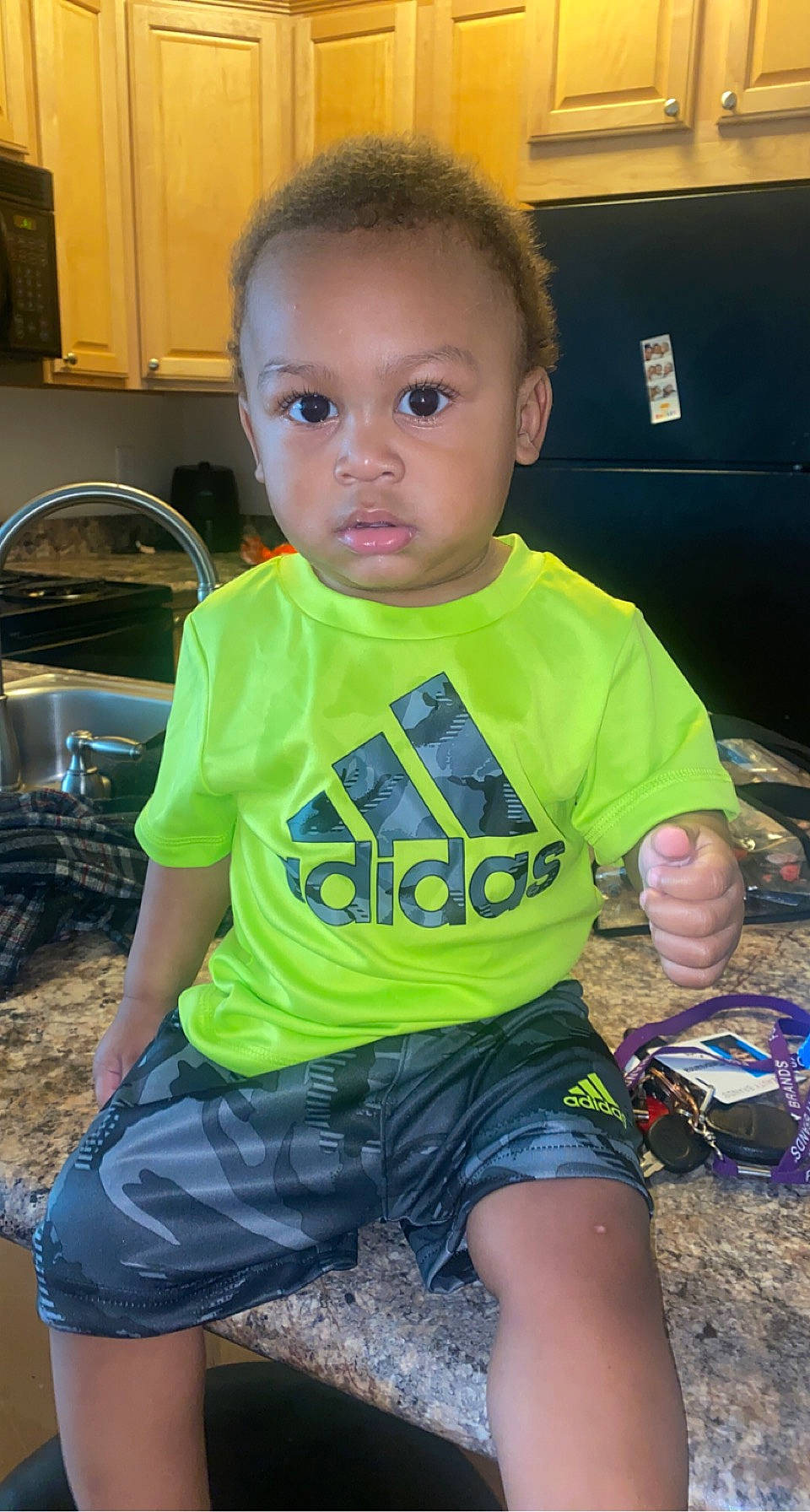 Kyree is registered to the contest to win money with this photo: baby_toddler_clothing, blue, child, facial_expression, finger, fun, grass, hairstyle, happy, kitchen_appliance, leg, organ, person, personal_protective_equipment, skin, sleeve, standing, t_shirt, thigh, toddler