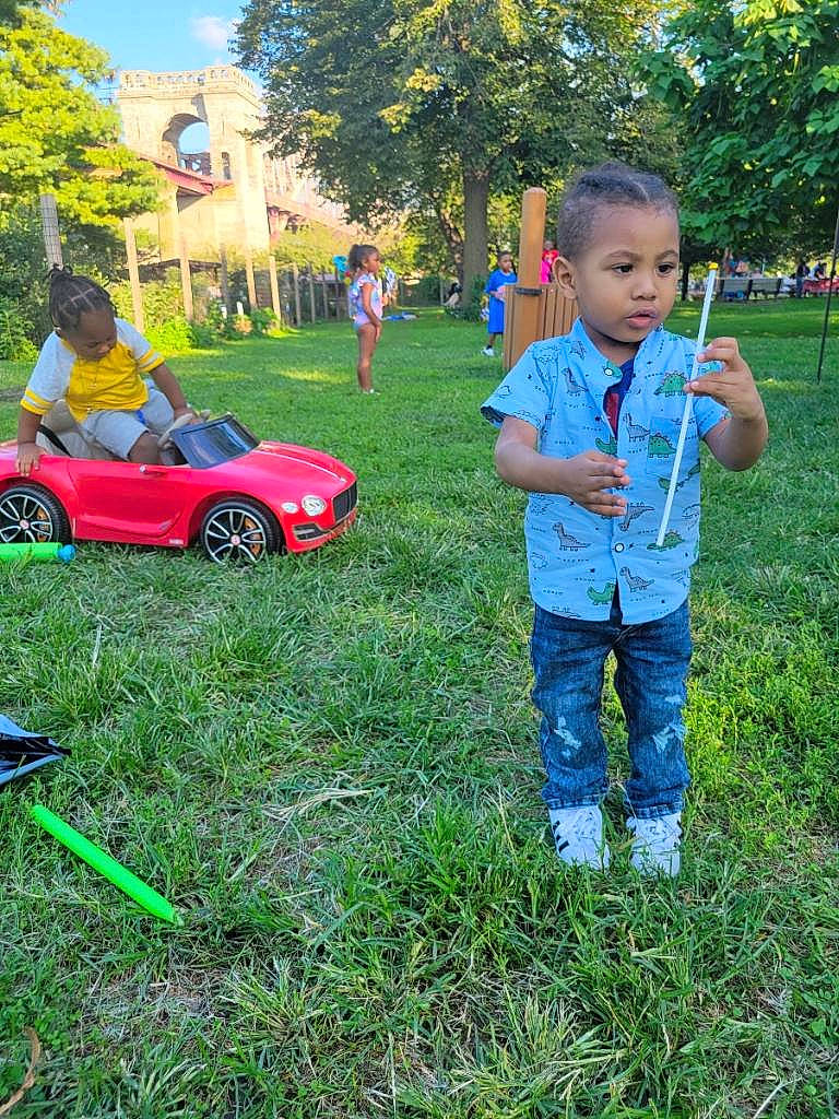 Bryce is registered to the contest to win money with this photo: automotive_design, automotive_exterior, car, fun, grass, grassland, hood, landscape, lawn, leisure, motor_vehicle, people_in_nature, person, plant, recreation, tire, toddler, tree, vehicle, vehicle_door