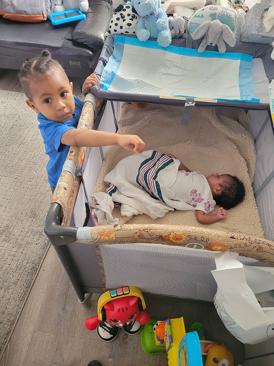 Bryce joined the competition — help win amazing prizes! baby, baby_products, baby_safety, child, comfort, fun, green, hat, human, leisure, person, product, shoe, shorts, sitting, sneakers, tire, toddler, travel, wheel